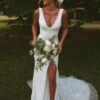 bride wearing sleeveless lace wedding gown with low back and train