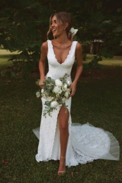bride wearing sleeveless lace wedding gown with low back and train