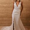 bride wearing lace fitted wedding gown with slit
