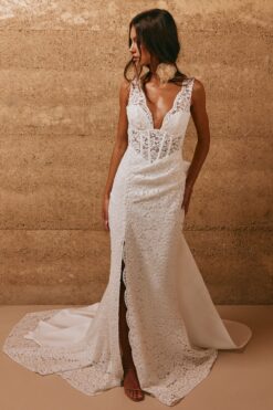 bride wearing lace fitted wedding gown with slit