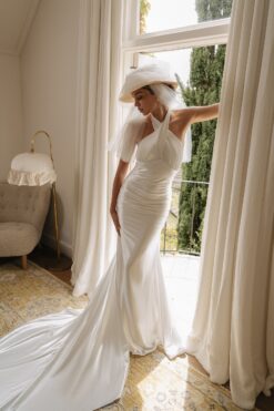 Halter satin wedding dress with open back and elegant train