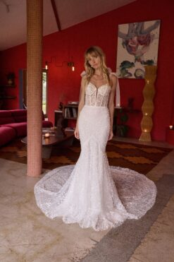 Bride seated wearing embellished mermaid wedding gown