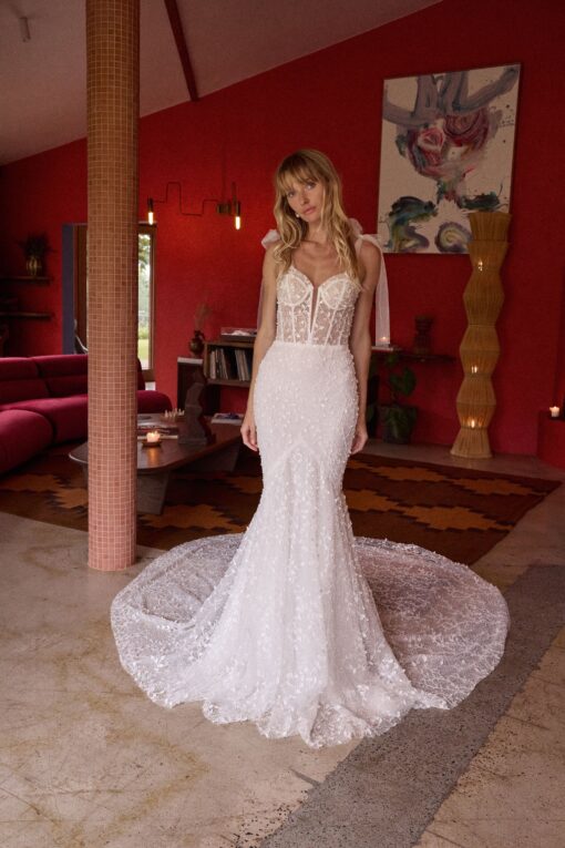 Bride seated wearing embellished mermaid wedding gown