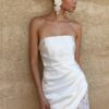 Satin mini wedding dress with strapless neckline and lace trim