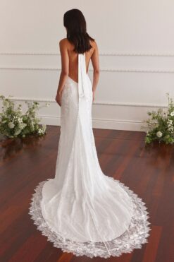Bride walking upstairs in lace backless wedding gown