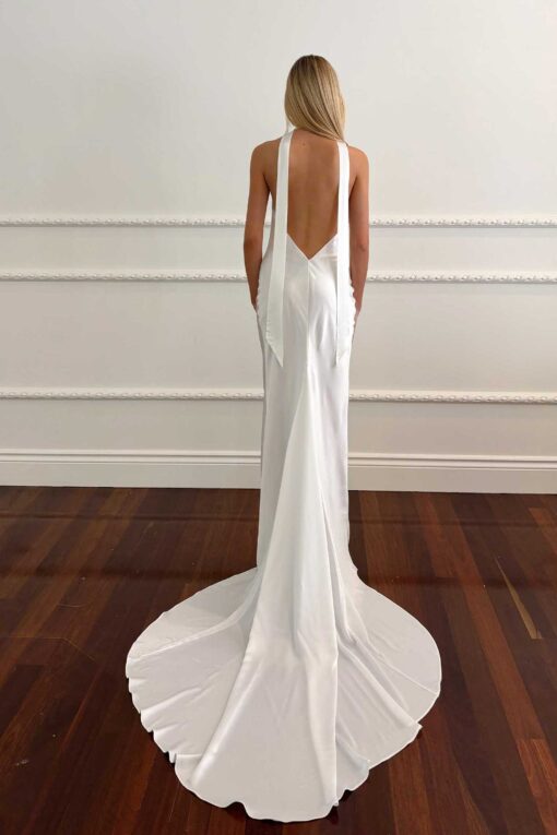 Back view of satin halter wedding gown with open back