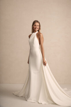 Bride in modern high-neck sheath wedding dress with chapel train