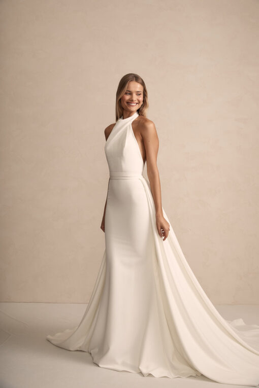 Bride in modern high-neck sheath wedding dress with chapel train